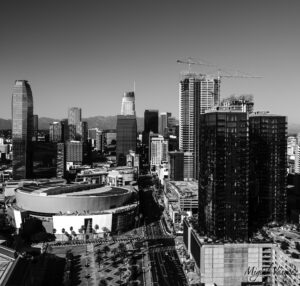 Aerial black and white view of the Downtown Los Angeles skyline with Staples Center in the foreground